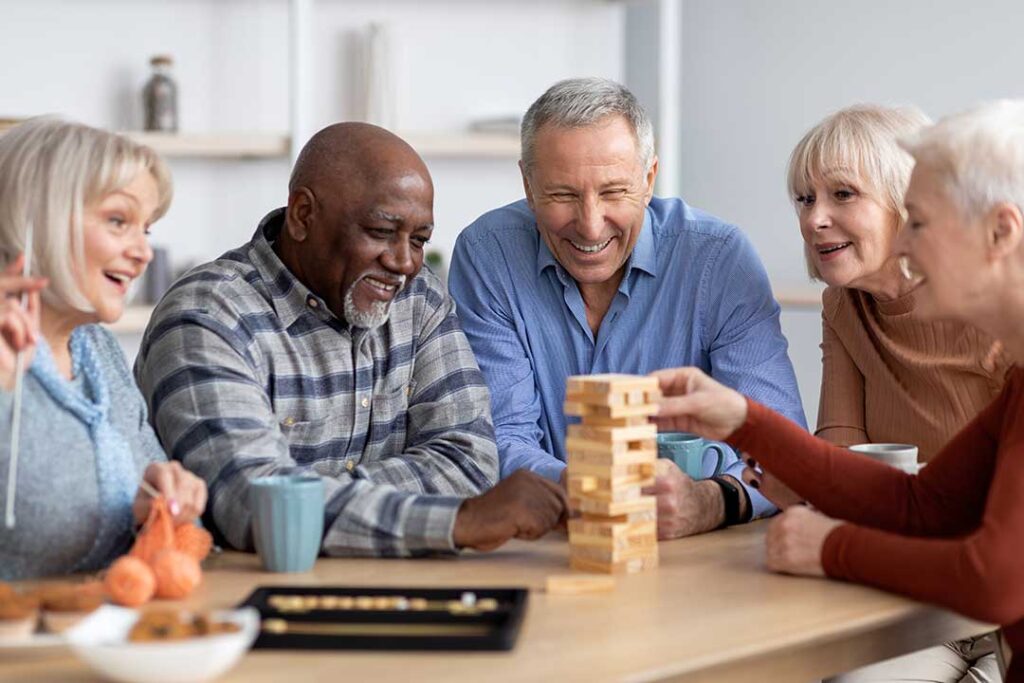 A resident decorating their private assisted living apartment with family photos and keepsakes.